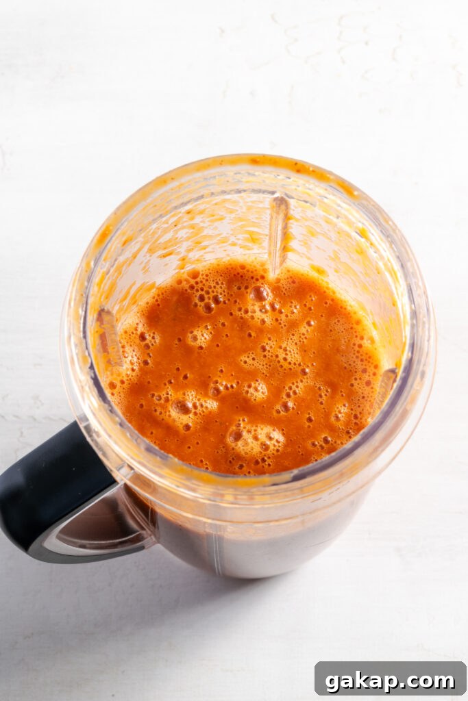 spicy red tinga sauce after blending the ingredients together.