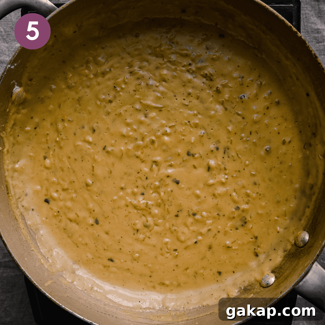 vegan bechamel sauce with caramelized onions in a frying pan