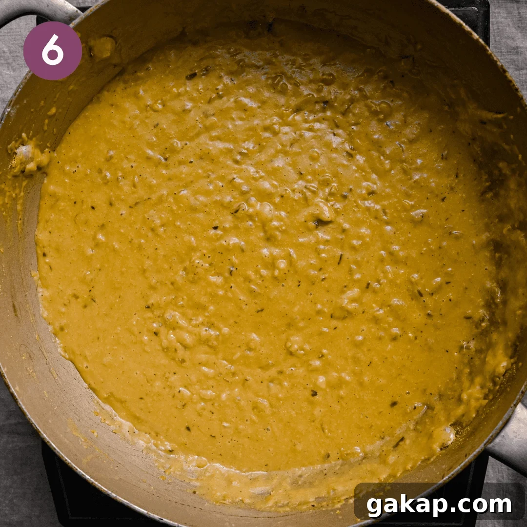 cheesy vegan bechamel sauce with caramelized onions in a frying pan