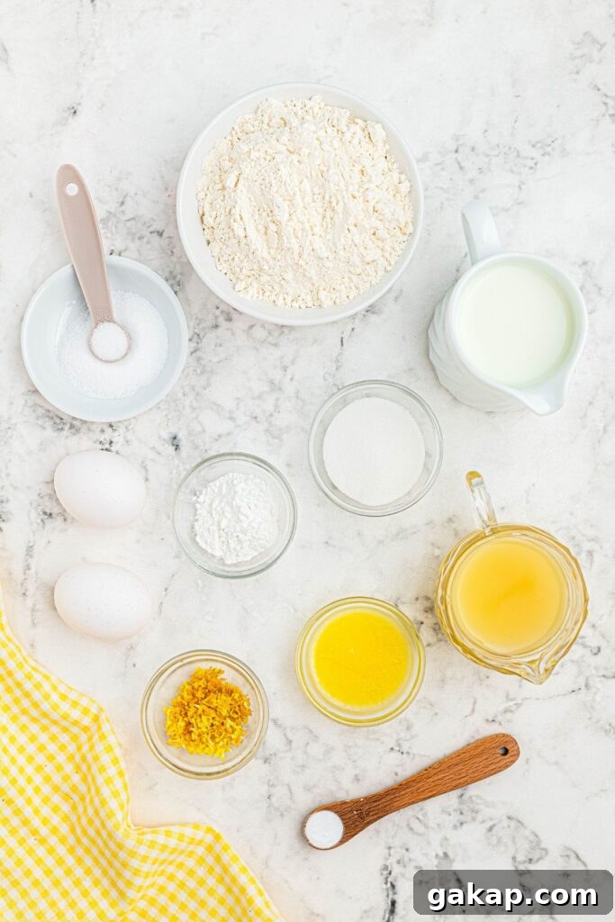 Lemon Pancakes Recipe: Fluffy Citrus Pancakes with Zesty Syrup 3 Ingredients measured in small bowls on a white marble table.