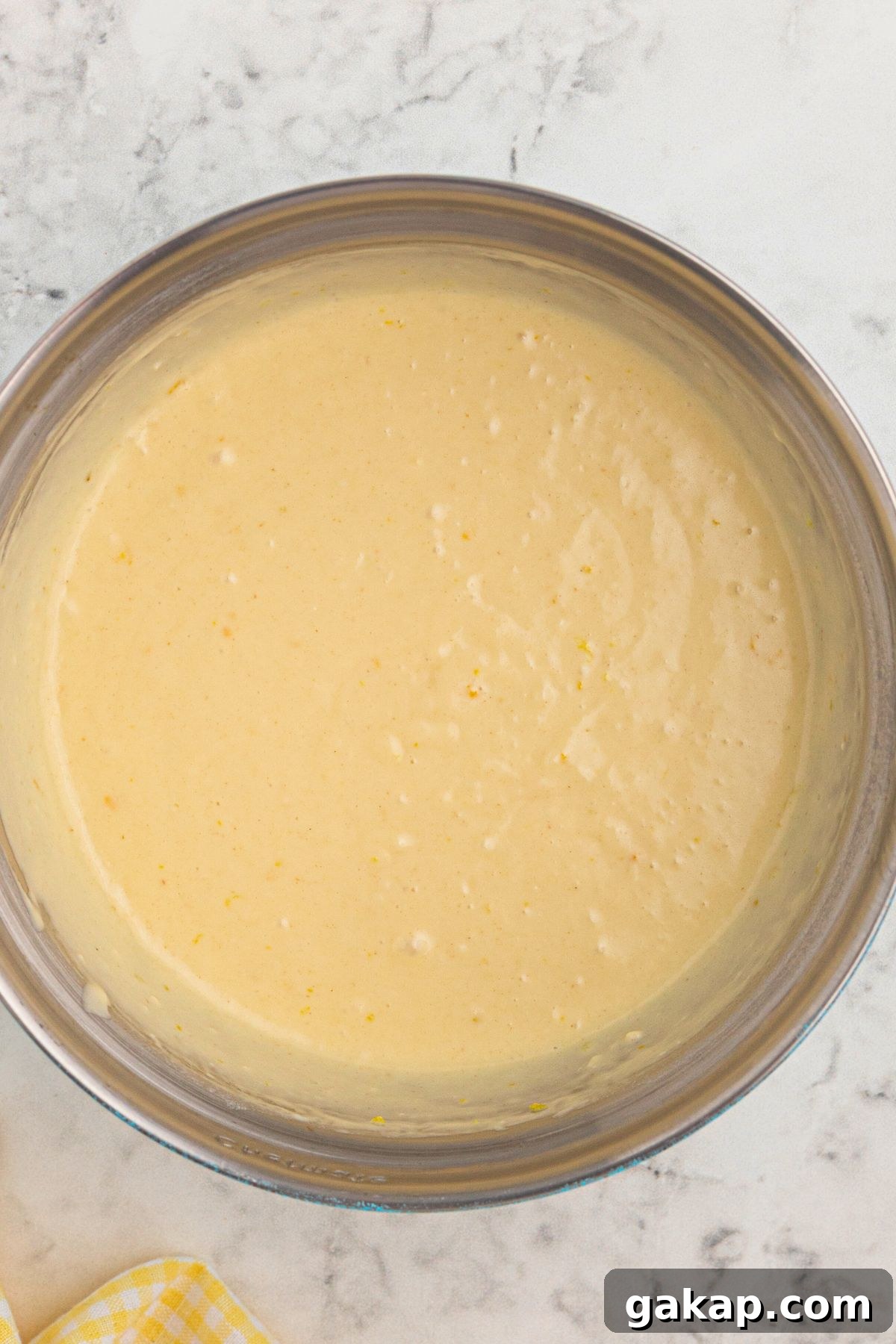 Lemon Pancakes Recipe: Fluffy Citrus Pancakes with Zesty Syrup 4 Pancake batter in a large clear glass bowl.