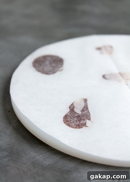 Perfect Ganache for Cakes: Step-by-Step Guide and Tips 5 White acrylic ganache 'lid' covered in baking paper.