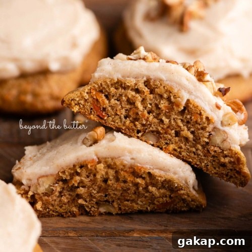 Brown butter cream cheese frosted and unfrosted carrot cake cookies with a sprinkling of chopped pecans around some of the cookies on a dark wood background.