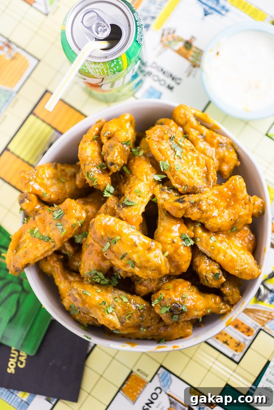 Crispy Baked Honey Lime Chicken Wings with Zesty Glaze 7 Sauce simmering with lime and honey.