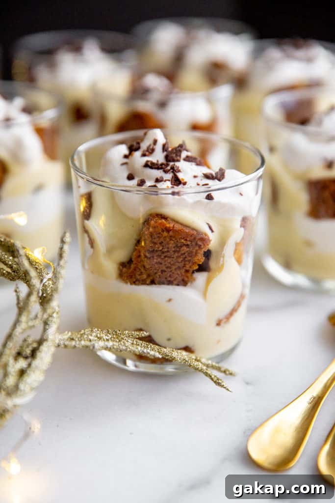 Gluten-Free Gingerbread Trifle Recipe — Festive Holiday Dessert 2 An individual gingerbread trifle in a glass with serving spoons alongside.