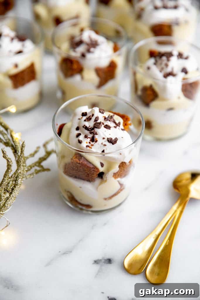 Gluten-Free Gingerbread Trifle Recipe — Festive Holiday Dessert 4 Individual gluten free trifles in serving glasses on a marble surface.