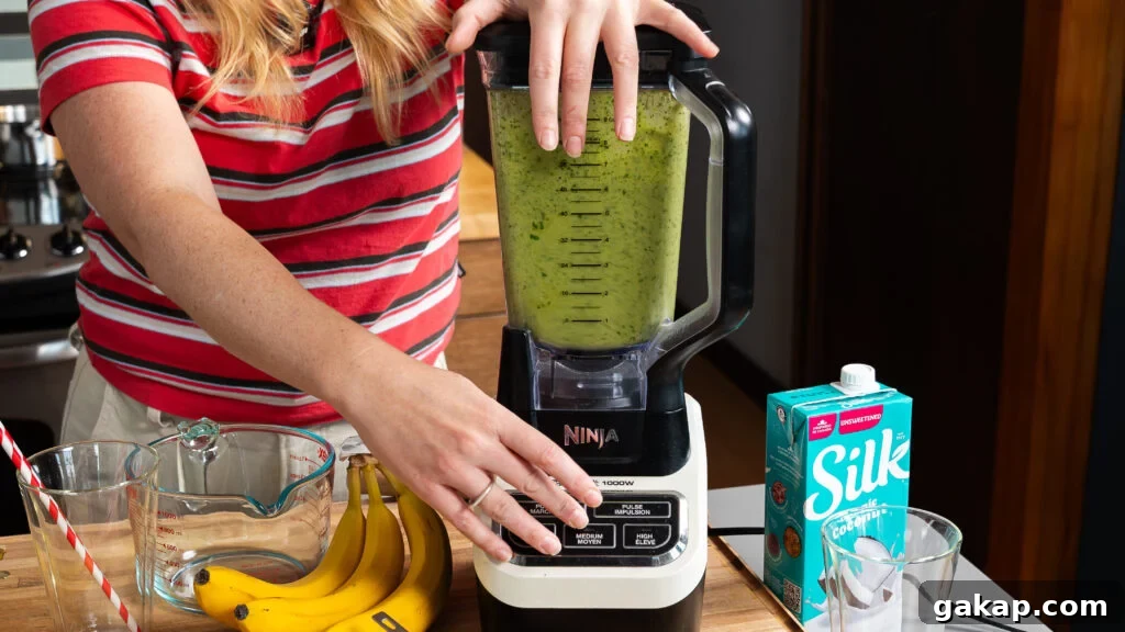 Tropical Green Island Smoothie — Ready in 5 Minutes 4 Blending an island green tropical smoothie in a blender.