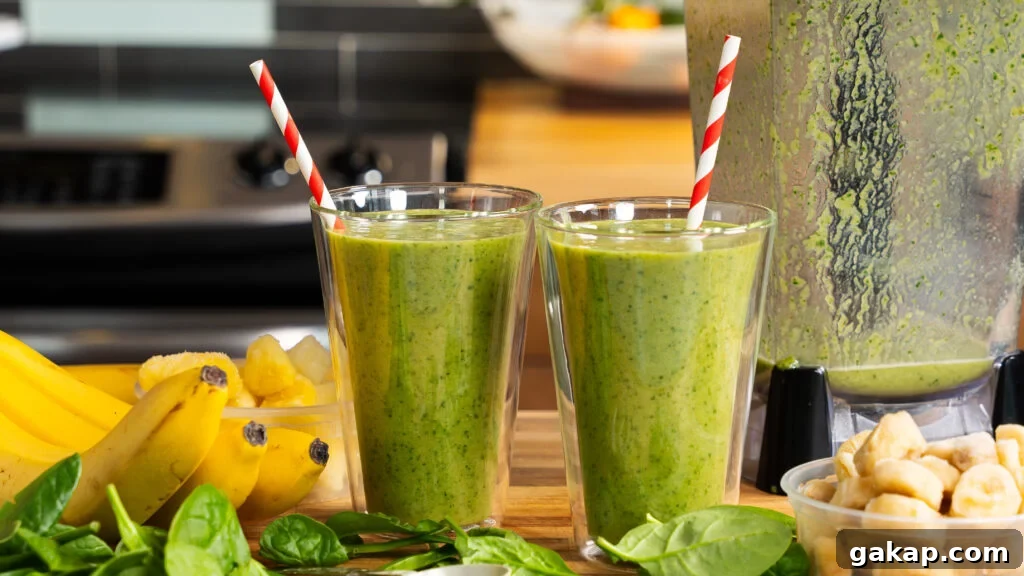 Tropical Green Island Smoothie — Ready in 5 Minutes 2 Island green tropical smoothies with striped straws.