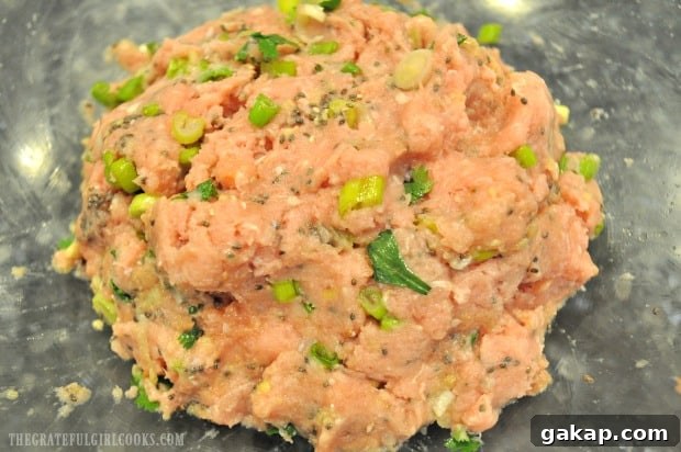 Meat mixture is ready to form Thai turkey meatballs for baking.
