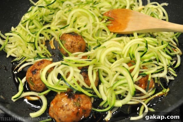 Thai turkey meatballs and zucchini noodles are added to glaze in skillet to cook for a few minutes.