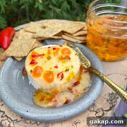 hot pepper jelly poured over creamy brie with crackers served on the side
