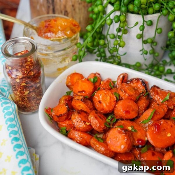 roasted carrot coins with parsley on white serving plate