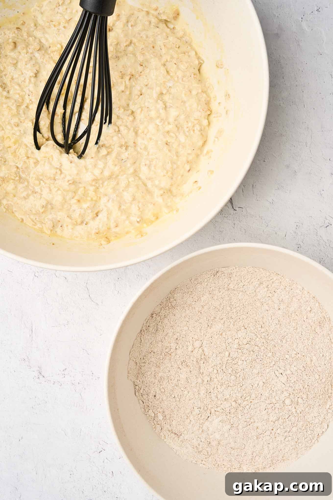 Buttermilk Apple Oat Muffins Recipe for Moist Breakfast 4 Preparing apple oatmeal muffins, a mixing bowl with quick-cooking oats, buttermilk, melted butter, and egg, another bowl with flour, cinnamon, and other dry ingredients.