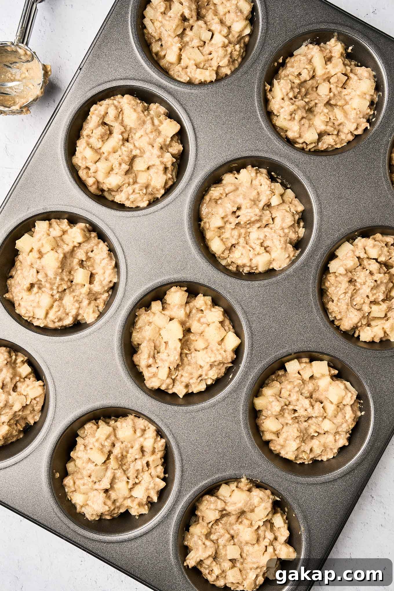 Buttermilk Apple Oat Muffins Recipe for Moist Breakfast 5 Apple cinnamon oatmeal muffin batter in the muffin tin, ready for the oven.