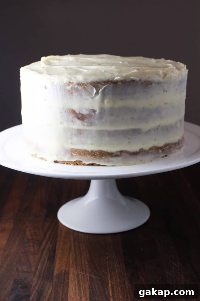 Frosted moist carrot cake on a stand