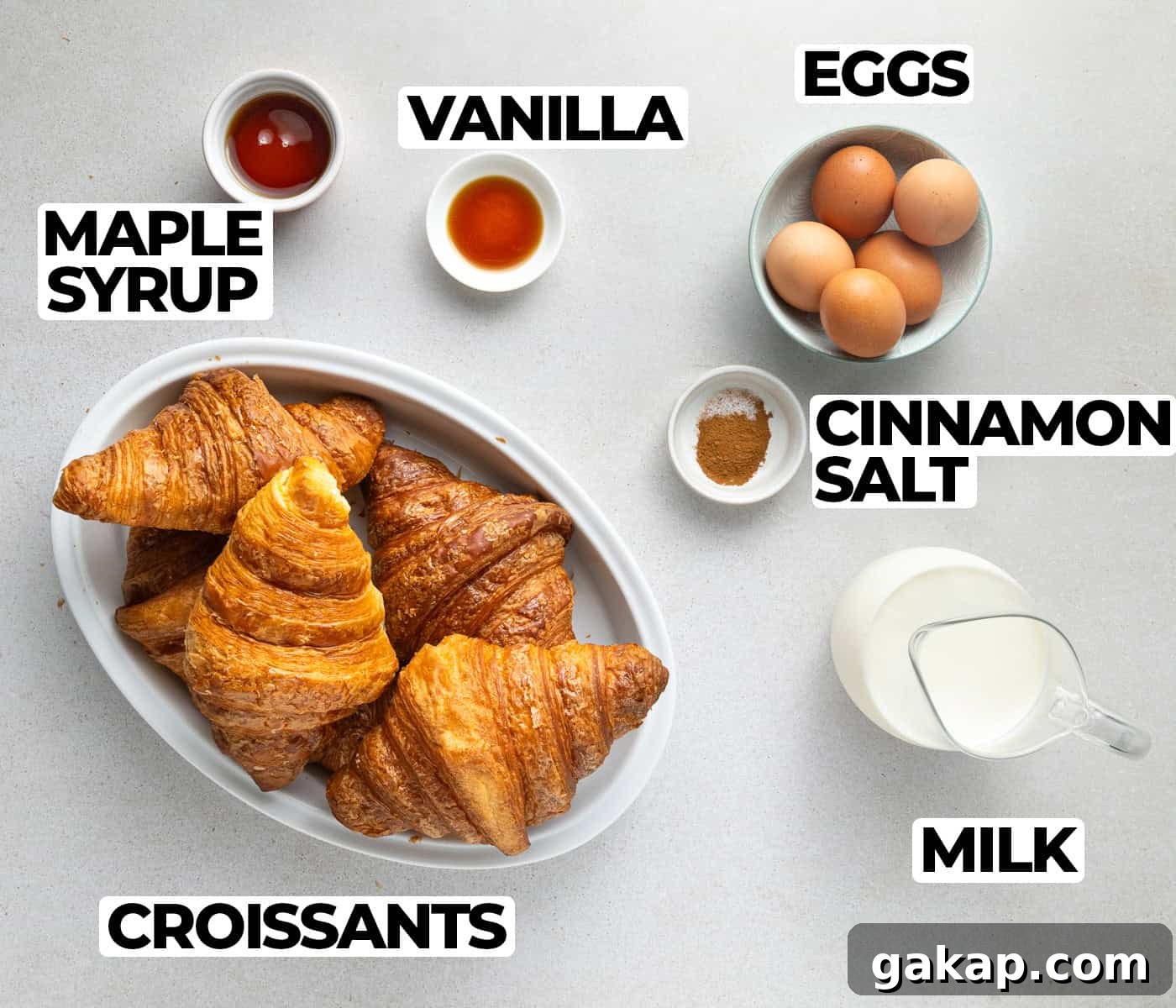 Decadent Croissant French Toast Casserole Recipe 3 Ingredients laid on a grey surface.