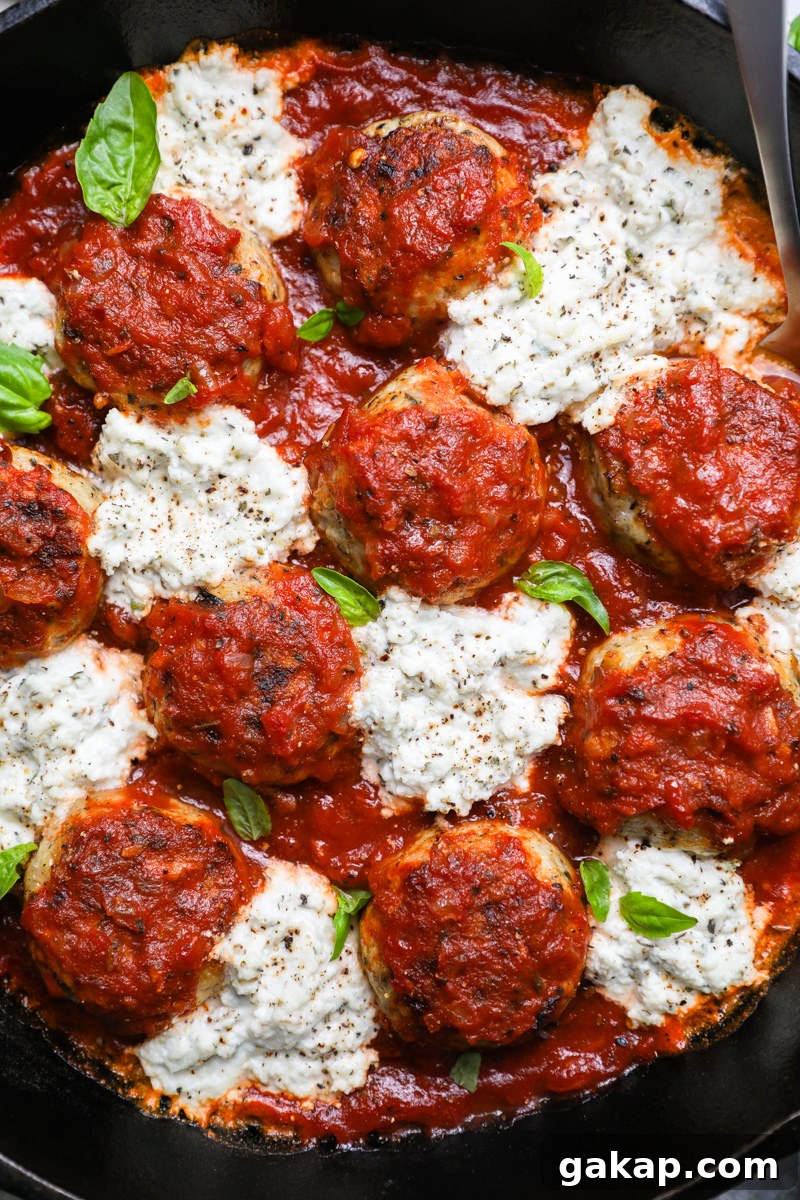 A close up photo of Italian chicken meatballs with herbed ricotta