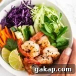 A close up view of a bowl of Vietnamese shrimp salad.
