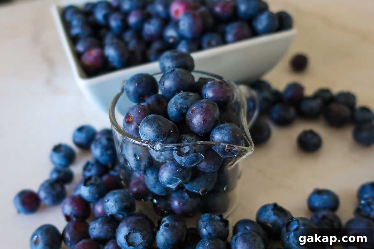 Fresh blueberries displayed in a glass jar and white bowl—perfect for gluten-free baking or smoothies
