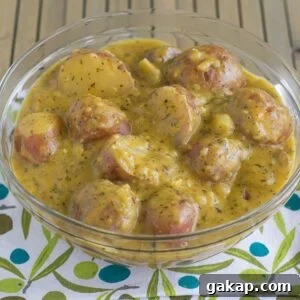 A bowl filled with crock pot cheesy ranch potatoes.