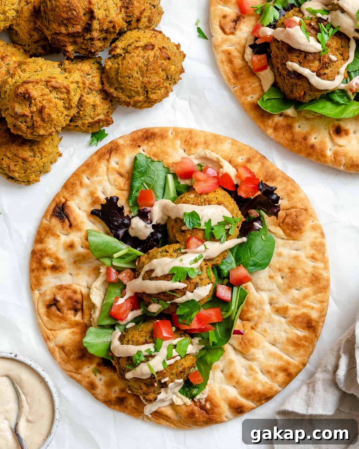 completed Healthy Baked Falafel on bread against a white background