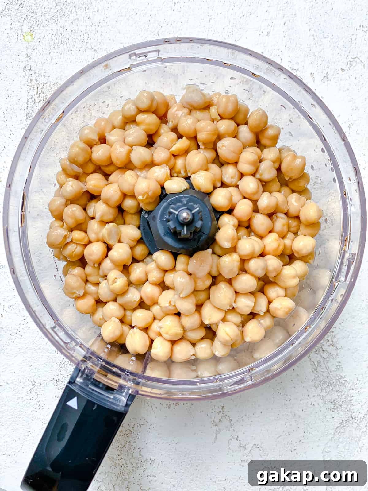 process shot of adding chickpeas to food processor