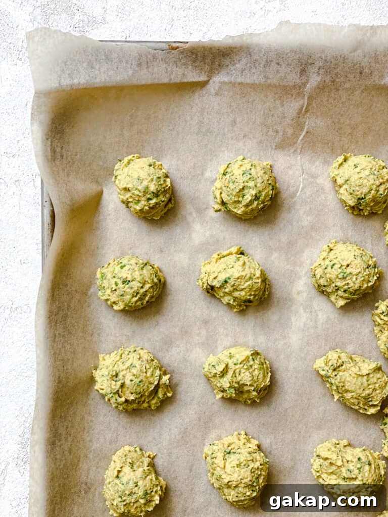 process shot showing unbaked falafel on baking sheet