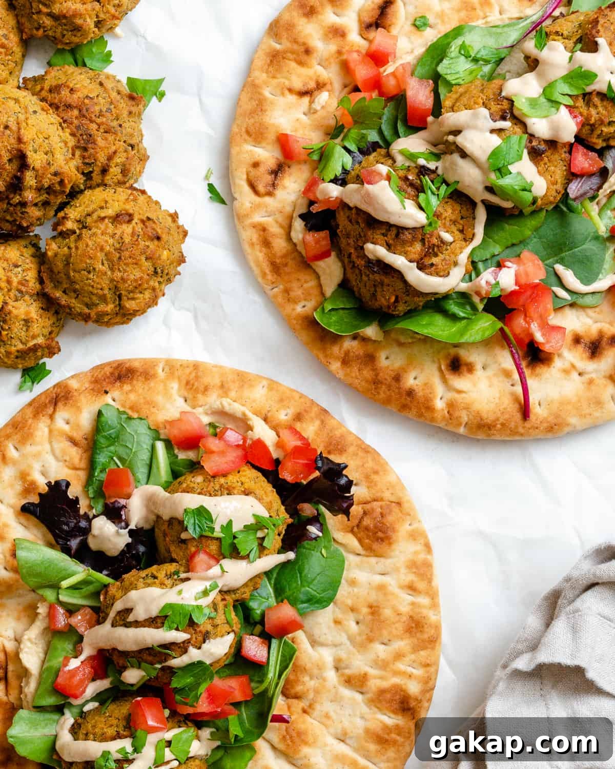 completed Healthy Baked Falafel on bread against a white background