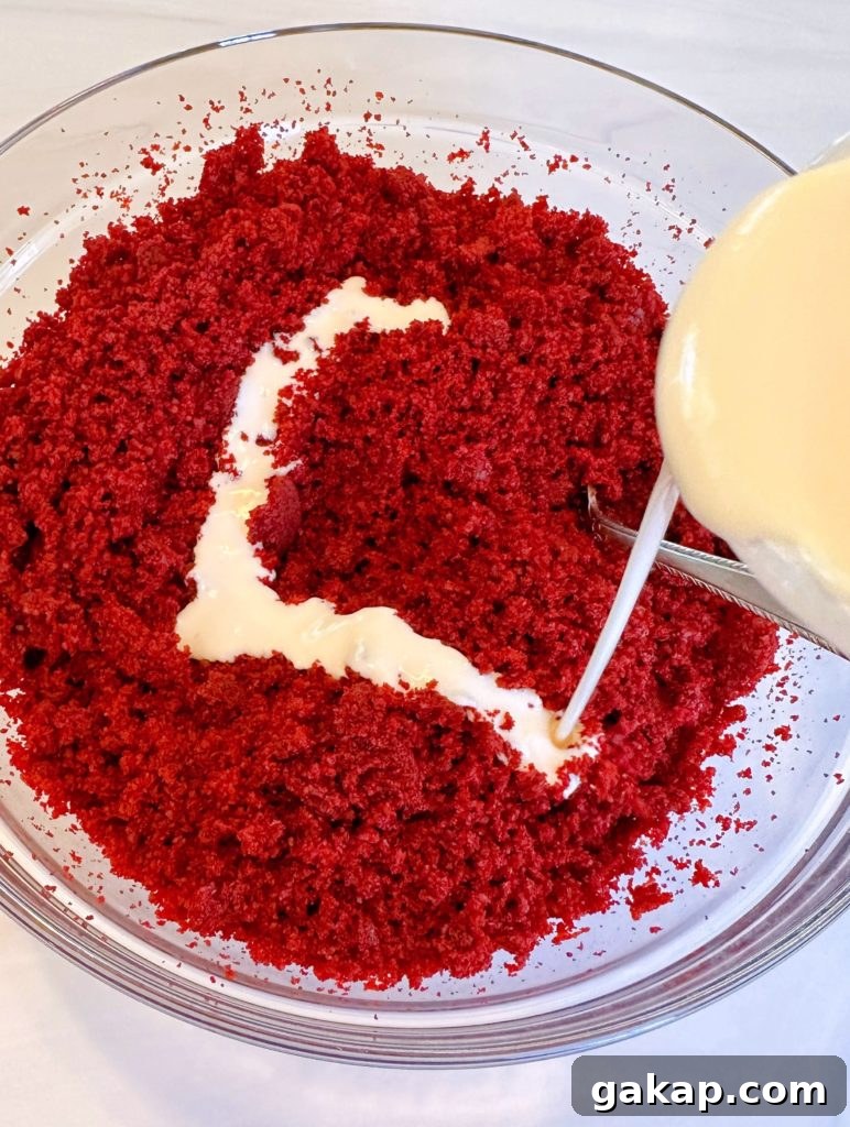 Red Velvet Cake Pops: Simple Party Dessert Recipe 5 Pouring melted frosting over cake crumbs.