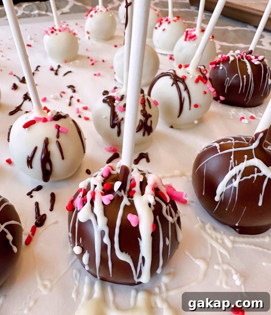 Red Velvet Cake Pops: Simple Party Dessert Recipe 8 Cake balls on a parchment lined table.