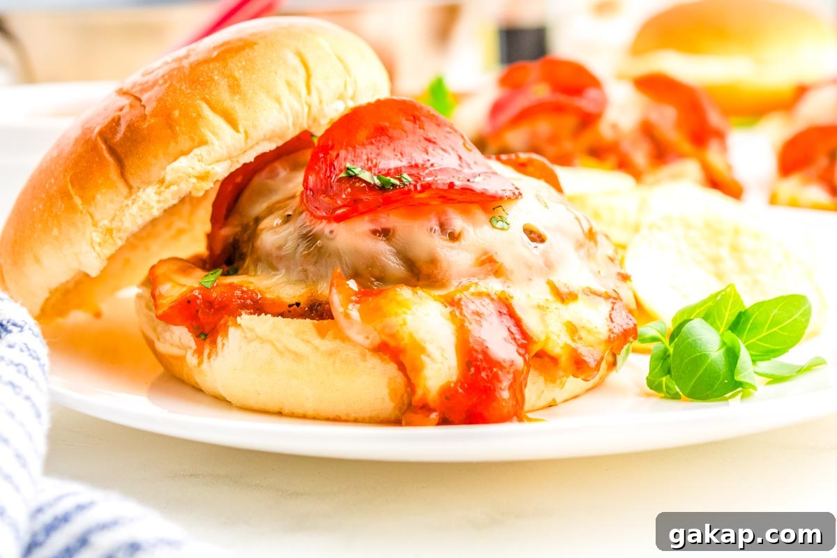 A pizza burger on a white plate.