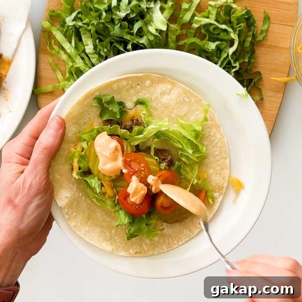 Copycat McDonald's Big Mac Wrap with Signature Sauce Recipe 9 Adding the special sauce to the wrap.