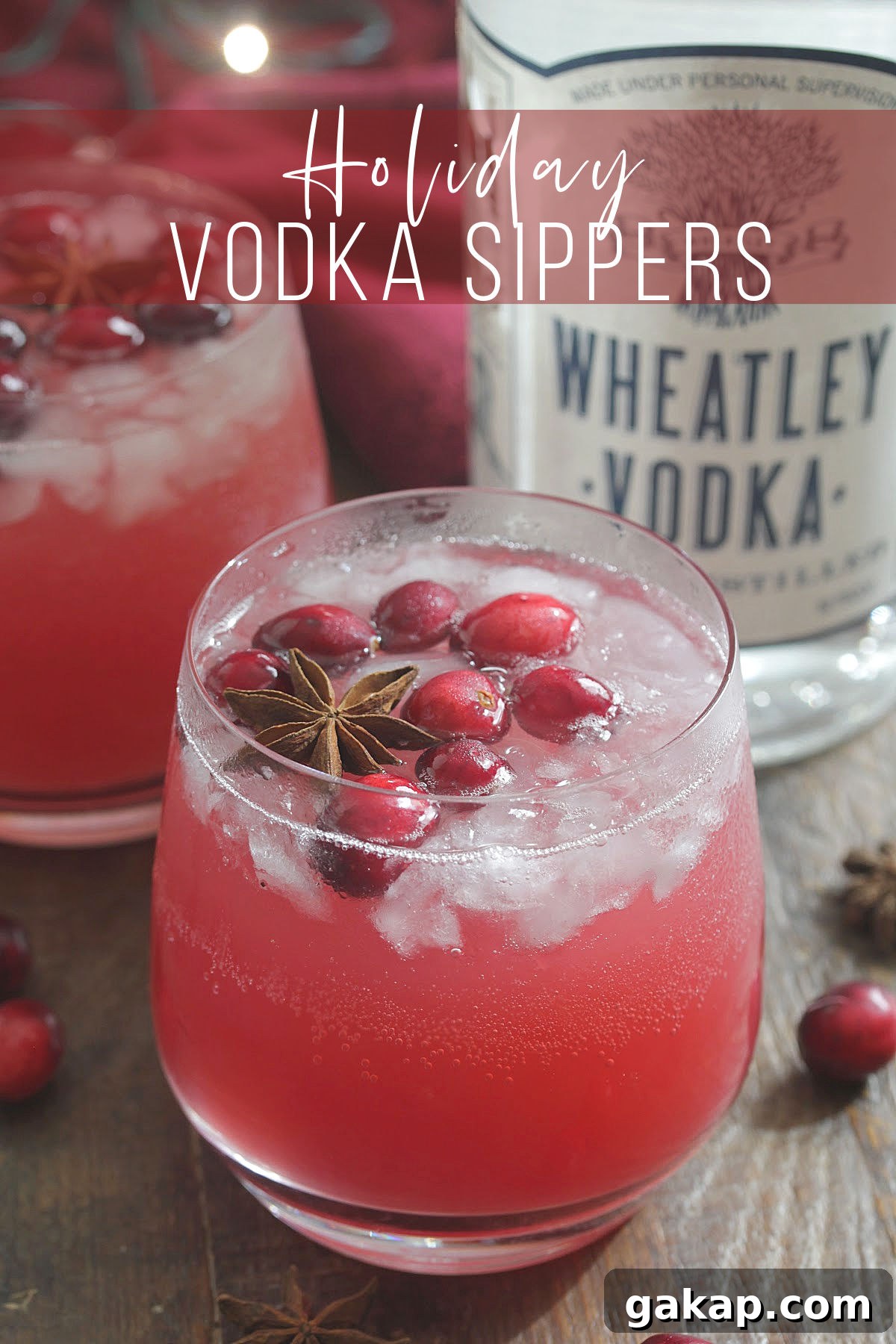 Festive Vodka Sippers: Holiday Cocktail Ideas for Parties 7 Bottle of Wheatley Vodka next to red holiday drink with cranberries