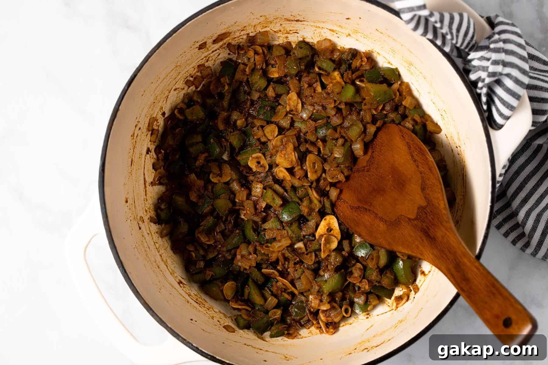 Sauteed veggies for chili in a large white pot