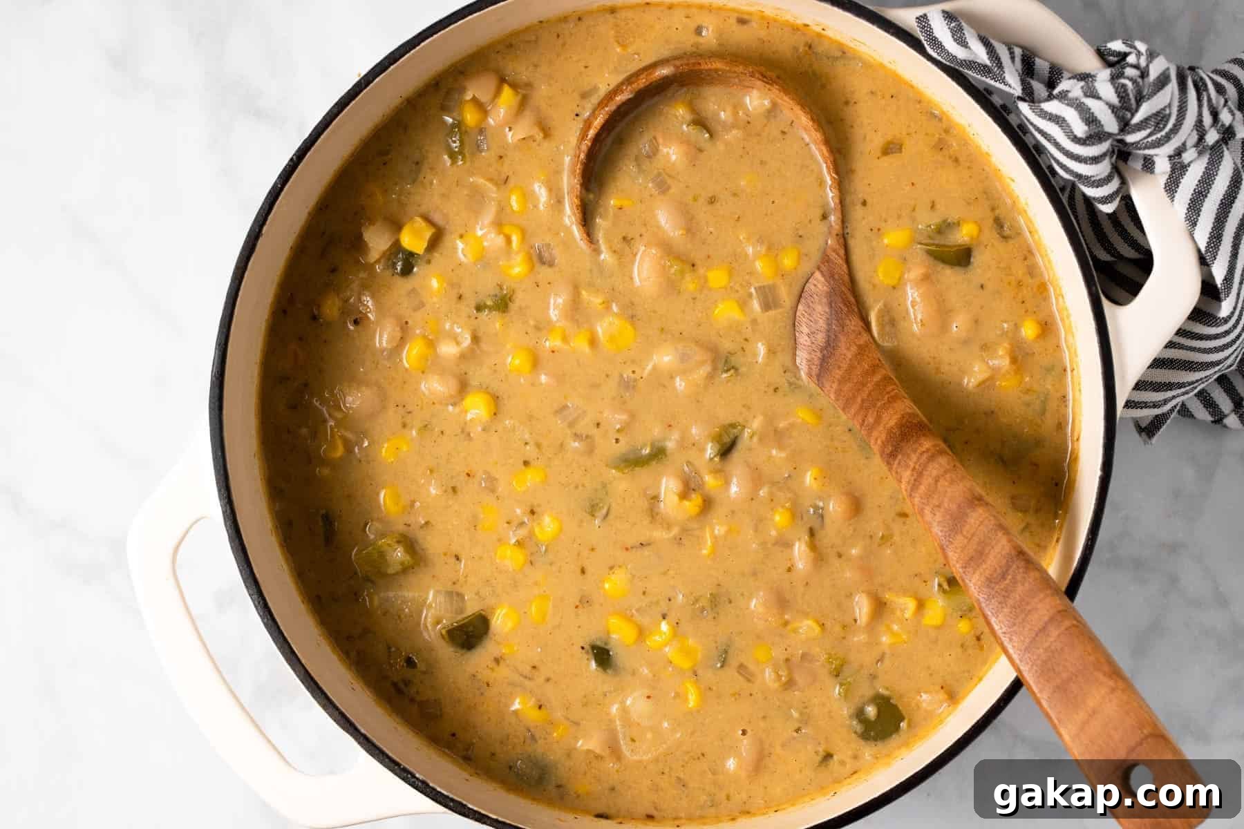 Large white pot filled with ingredients to make white bean chili