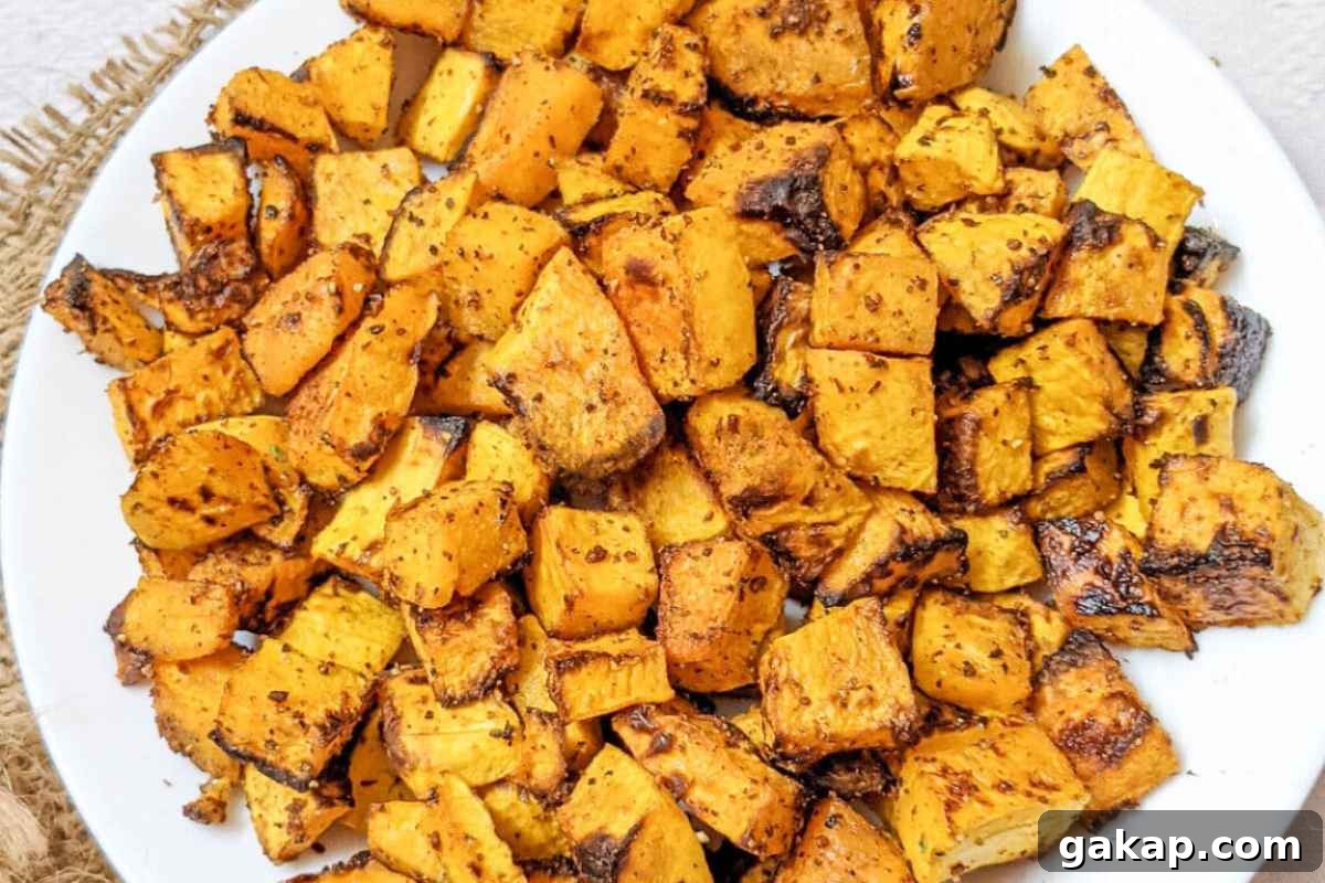 Holiday Air Fryer Recipes to Simplify Your Cooking 15 Roasted butternut squash cubes on a plate