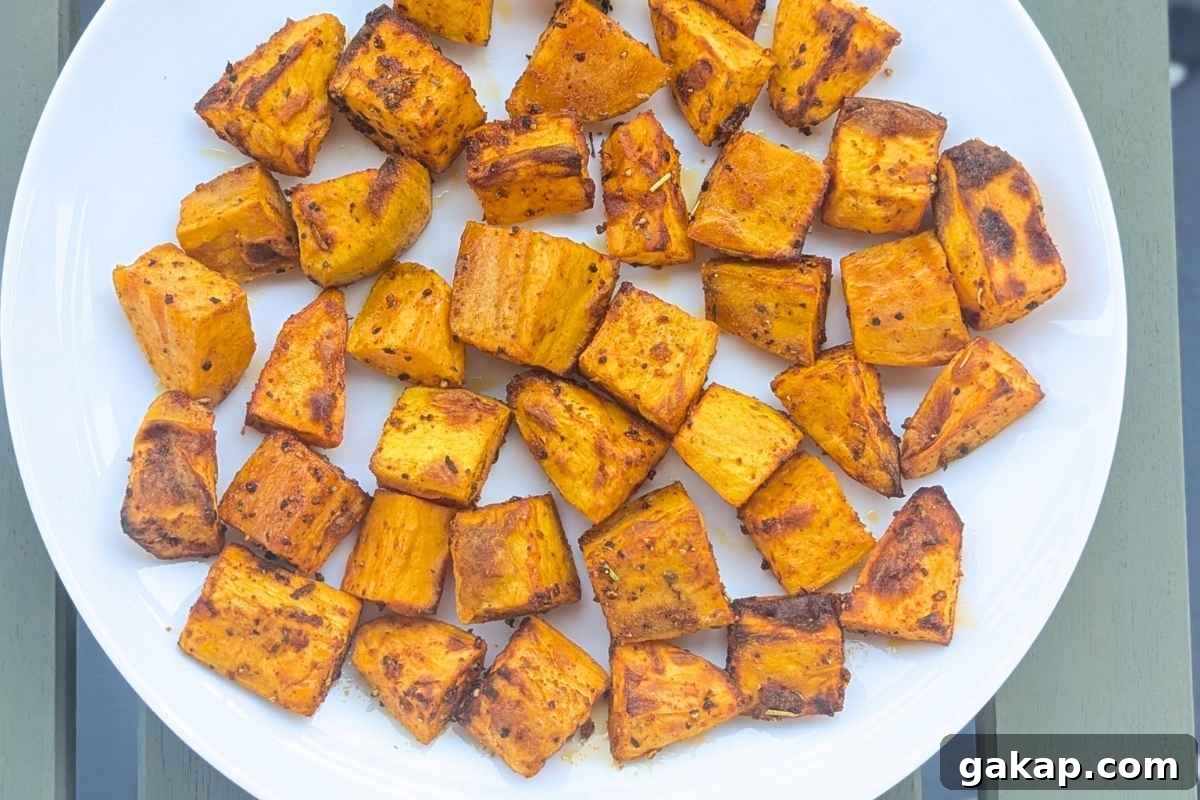 Holiday Air Fryer Recipes to Simplify Your Cooking 16 Air fried sweet potato cubes on a plate.
