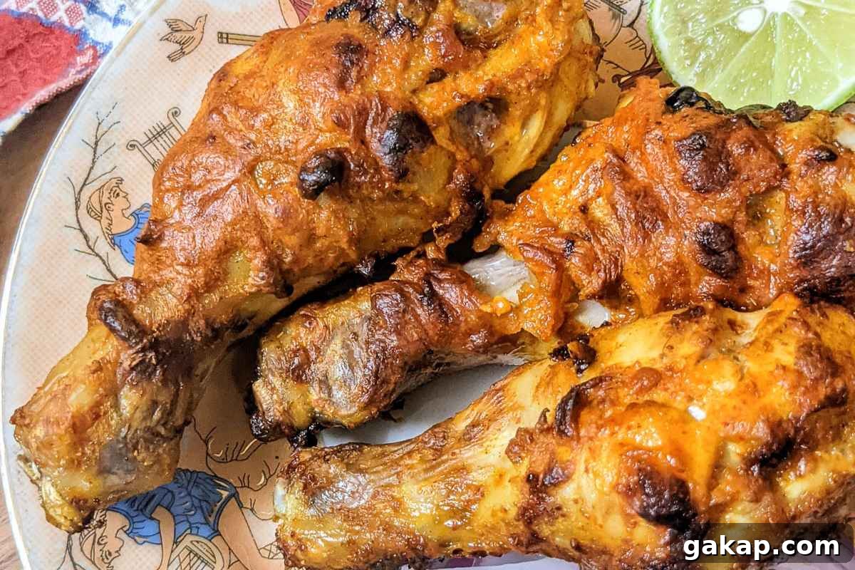 Holiday Air Fryer Recipes to Simplify Your Cooking 5 Tandoori Chicken drumsticks on a plate