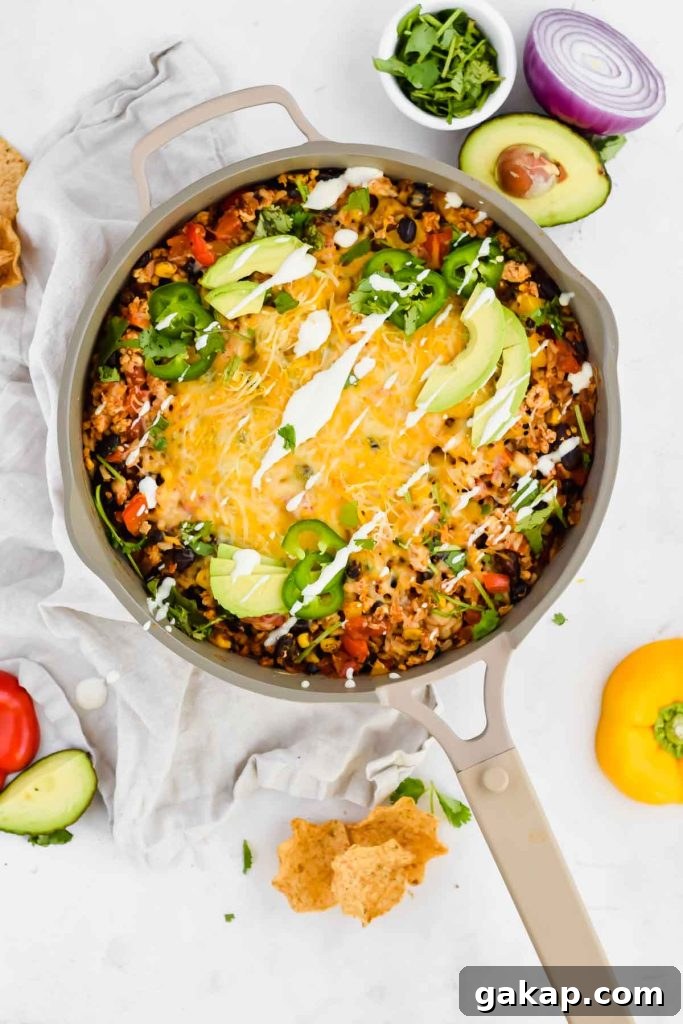 Cheesy Mexican Chicken Skillet in a tan pan
