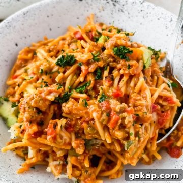 one serving of mexican spaghetti on white speckled serving plate.