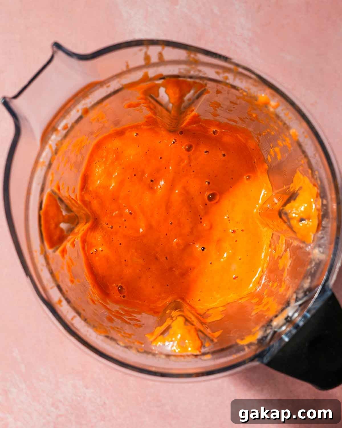 Creamy Roasted Red Pepper & Tomato Pasta Recipe 6 Inside of a blender of a mix of roasted red peppers and tomatoes for pasta sauce.