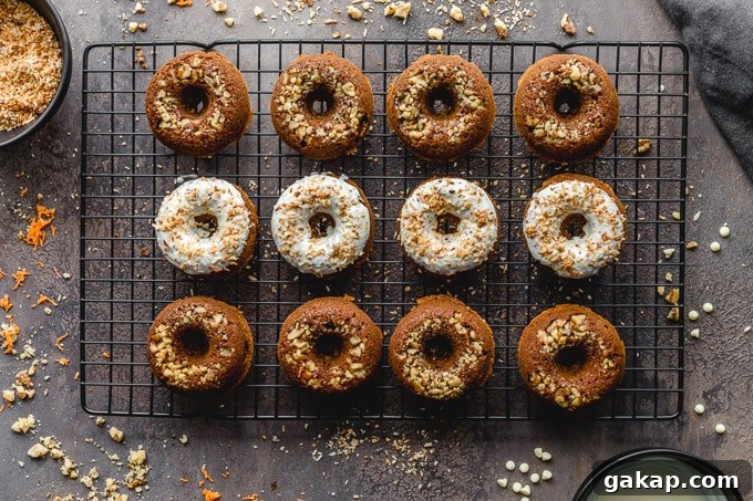 Gluten-Free Carrot Cake Donuts: Soft Spiced Donut Recipe 9 Donuts arranged on a wire rack, with some dipped in white chocolate.