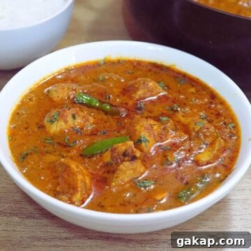chicken handi served in a white bowl.