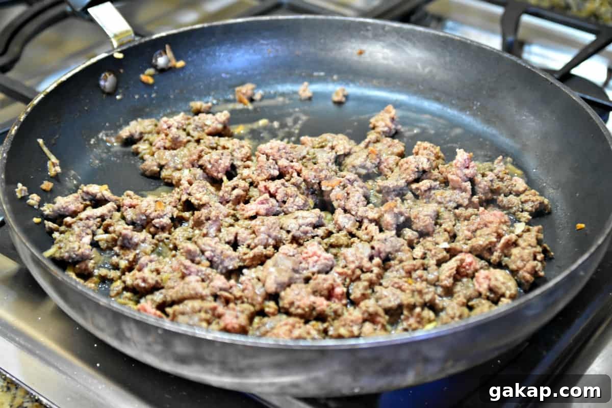 Baked Bacon Cheeseburger Sliders Recipe for Game Day and Parties 6 ground beef and onions in a skillet
