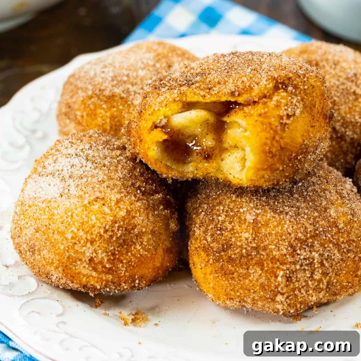Air Fryer Apple Pie–Stuffed Biscuits: Quick Cinnamon Dessert 2 Air Fryer Apple Pie Stuffed Biscuits on a plate.