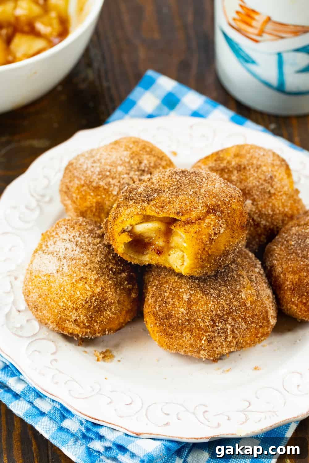 Air Fryer Apple Pie–Stuffed Biscuits: Quick Cinnamon Dessert 6 Apple Pie Stuffed Biscuits on a plate.
