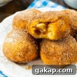 Air Fryer Apple Pie–Stuffed Biscuits: Quick Cinnamon Dessert 8 Air Fryer Apple Pie Stuffed Biscuits on a plate.