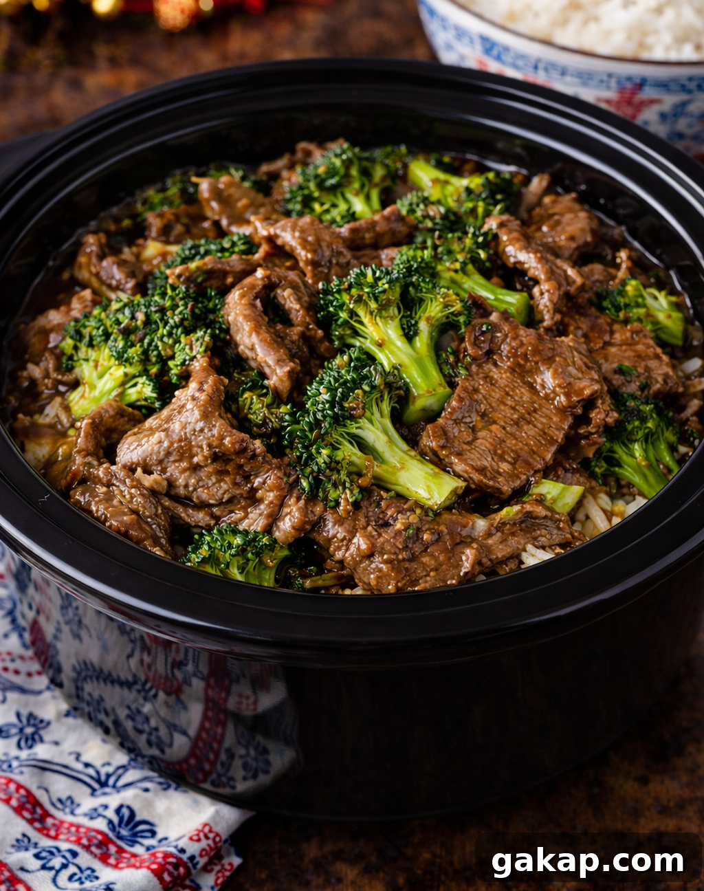 Slow Cooker Beef & Broccoli in a a black slow cooker 