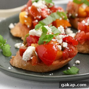 Tomato and Feta Bruschetta Recipe: Fresh Mediterranean Appetizer 6 A close-up of tomato feta bruschetta topped with diced tomatoes, yellow peppers, crumbled feta cheese, and fresh basil, served on a green plate.