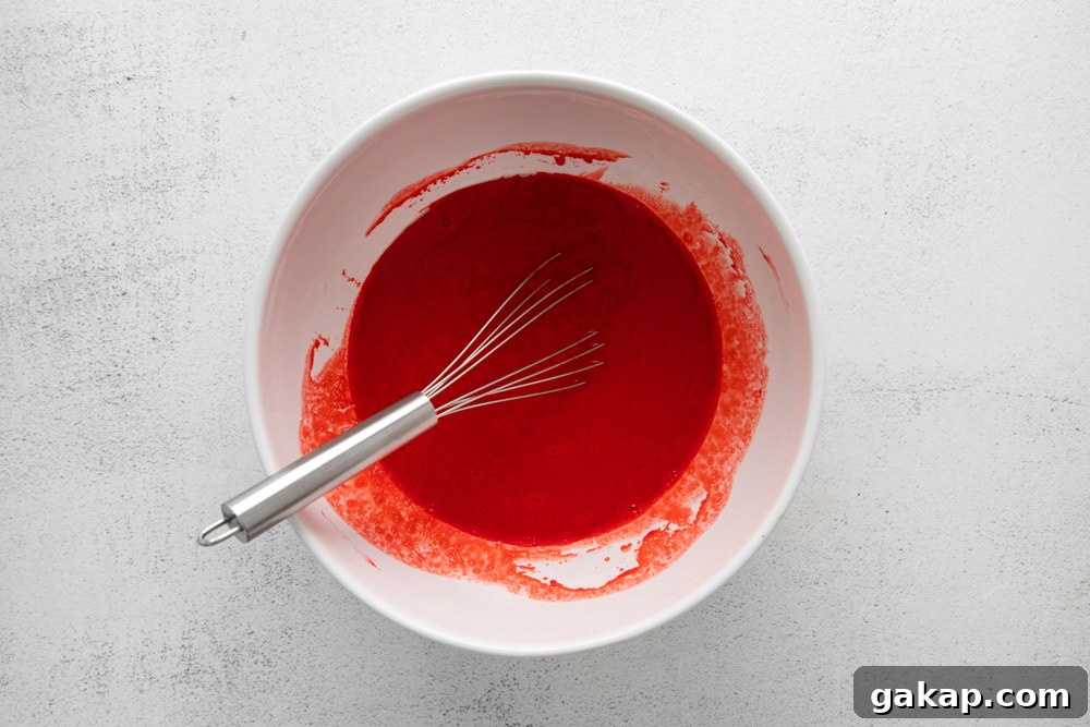 Decadent Red Velvet Cupcakes with Cream Cheese Frosting 6 red cupcake batter in a bowl.
